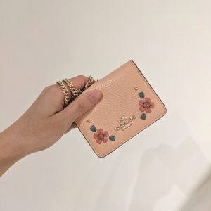 Limited edition Coach coral mini wallet on a gold chain